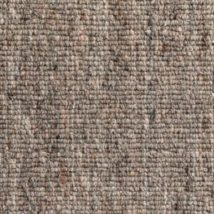 Vista ravvicinata di un tessuto strutturato con un mix di marrone, grigio e toni tenui. La superficie presenta un motivo ruvido e a spirale con piccole macchie di colore, perfetto per creare il caratteristico look Bozza automatico.